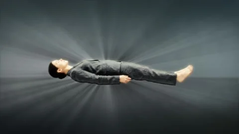 Surreal 3D Animation of a Human Levitating in Mid-Air with Glowing Light Rays Stock Footage 332621351