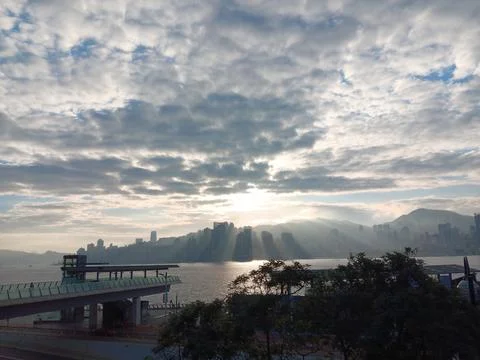 Surreal cloudscape during sunrise over harbor Stock Photos