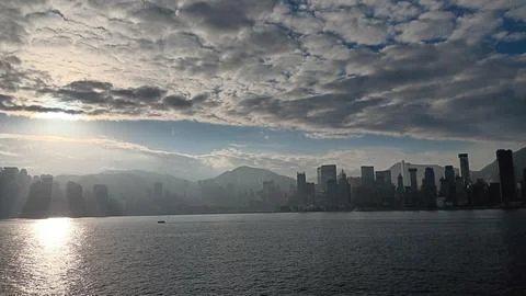 Surreal cloudscape during sunrise with reflection over harbor Stock Photos