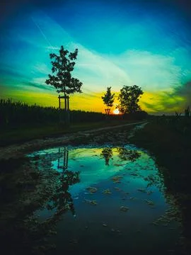 Surreal sunset reflection in a puddle with turquoise sky near Rajhrad, Czech Stock Photos