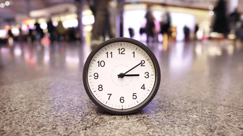 Surreal time lapse, clock with fast spinning hands at busy airport, close-up Stock Footage 345643980