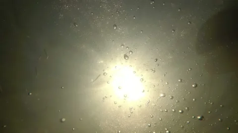 Surreal underwater view. The camera sinks to the bottom and looks at the bright 스톡 동영상 148447228
