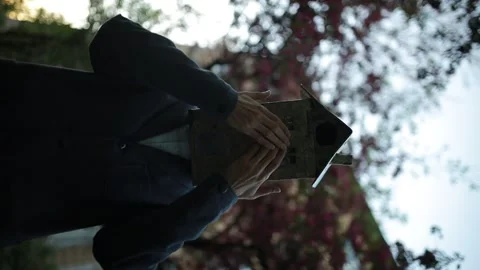 Surreal video. mystical man in a jacket with a paper house on his head. Stock Footage