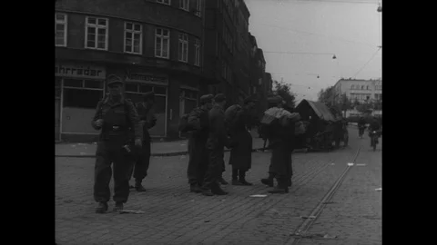 Surrendering German soldiers walk through town Stock Footage 103378830