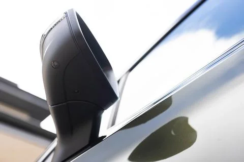 Surround view camera system in modern car, camera lens underneath side mirror Stock Photos
