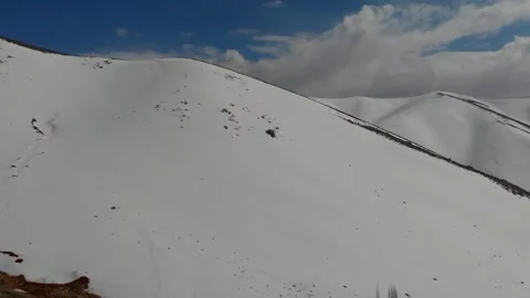 Surrounded by snow capped peaks one foreground mountain, stock footage. Stock Footage 304866454