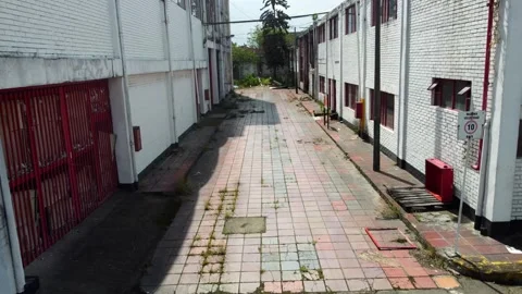 Surrounding the factory, a patchwork of warehouses and factories sprawls Video stock 273506600