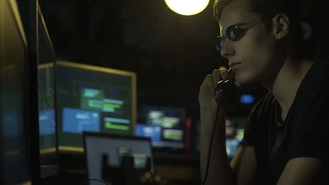 Surveillance agent and hacker answering a phone call Stock Footage 92163261