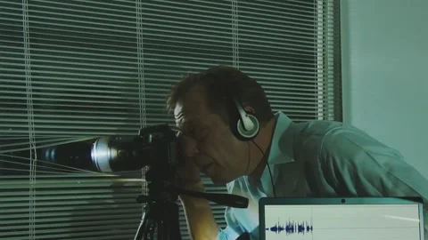 Surveillance and wiretapping: an agent in a suit records sounds and video from o Video stock 310174726