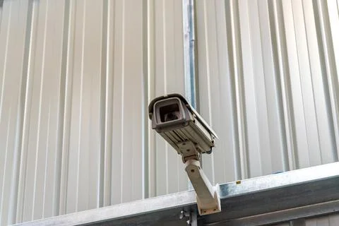 Surveillance camera attached on the wall Stock Photos
