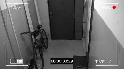 Surveillance camera caught the thief broke the door and stole the bike Stock Footage