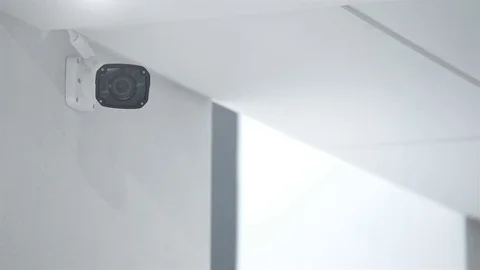 Surveillance camera hanging in an office building on the white wall. Stock Footage 83032417