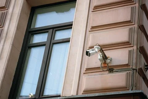 A Surveillance Camera Has Been Installed and Mounted Outside a Building for Stock Photos