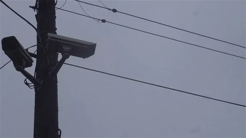 Surveillance camera on a lamp post on blue sky background.CCTV Video stock 82121101