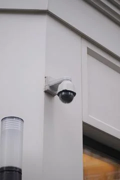Surveillance camera mounted on a building corner Stock Photos