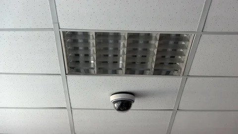 Surveillance Camera At Office. Security System Camera Hangs From Ceiling Stock Footage 74009828