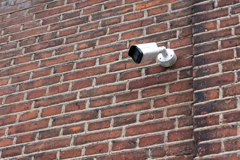 Surveillance camera on old brick wall Stock Photos