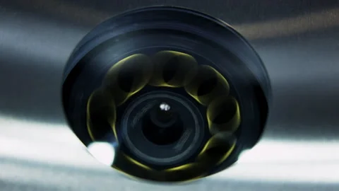 Surveillance camera showing rotating blurred yellow liquid ring. Media Stock Footage 315270530