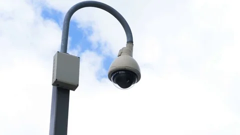 Surveillance camera on a street lamp: security, control, anti-terrorism Stock Footage 78078985