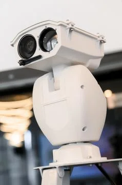 Surveillance camera system mounted on a white pedestal in modern setting 스톡 사진