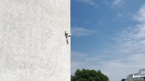 Surveillance camera on the wall of the building Stock Footage 245236934