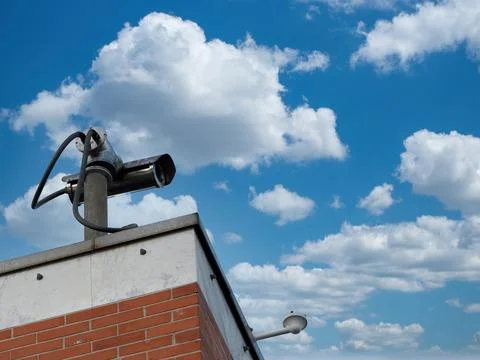 The surveillance camera on a wall of building . security videocamera(CCTV) .. Stock Photos