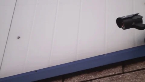 Surveillance camera on the wall of the enterprise Stock Footage 74645385