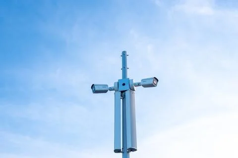 Surveillance cameras to control protected area on high pole Stock Photos