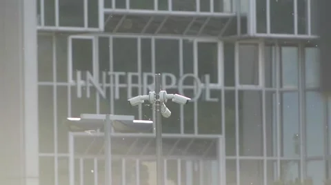 Surveillance cameras with INTERPOL building on background Vídeo Stock 43914482