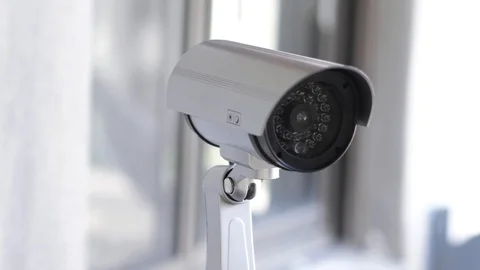 Surveillance CCTV Security Camera Moving Itself Around Near Building Stock Footage
