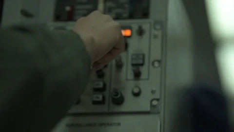 Surveillance operator adjusting control panel onboard E-3 Sentry Video stock 97818866