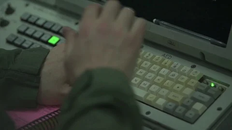 Surveillance operator using computer onboard E-3 Sentry Stock Footage 97818844