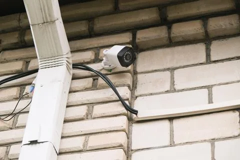 Surveillance security camera video equipment on house wall outdoor Stock Photos