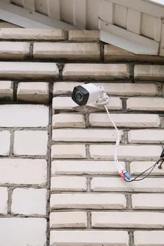 Surveillance security camera video equipment on house wall outdoor Stock Photos