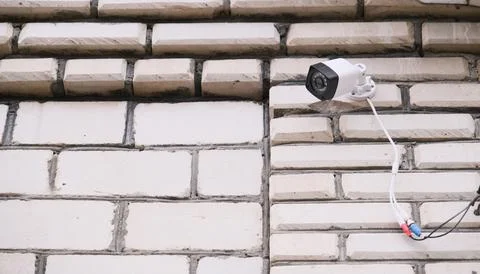 Surveillance security camera video equipment on house wall outdoor Stock Photos