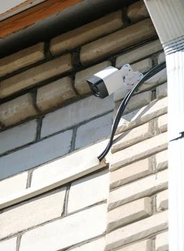 Surveillance security camera video equipment on house wall outdoor Stock Photos