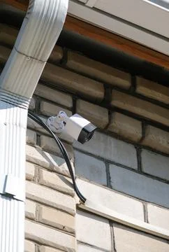 Surveillance security camera video equipment on house wall outdoor Stock Photos