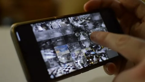 Surveillance security technology cctv on the phone monitor. split screen display Stock Footage 169626875