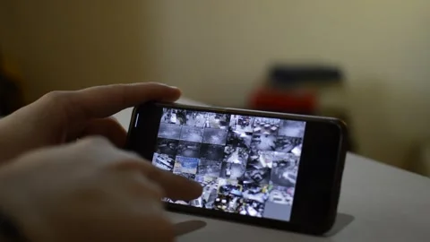 Surveillance security technology cctv on the phone monitor. split screen display Stock Footage 169626962