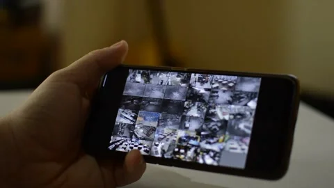 Surveillance security technology cctv on the phone monitor. split screen display Stock Footage 169627034