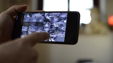 Surveillance security technology cctv on the phone monitor. split screen display Stock Footage 169627158