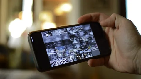 Surveillance security technology cctv on the phone monitor. split screen display Stock Footage 169627213