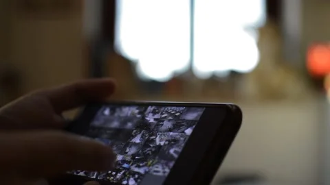 Surveillance security technology cctv on the phone monitor. split screen display Stock Footage 169627243