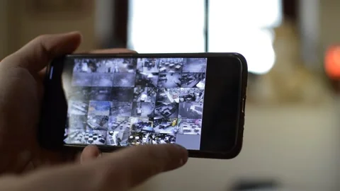 Surveillance security technology cctv on the phone monitor. split screen display Stock Footage 169627270