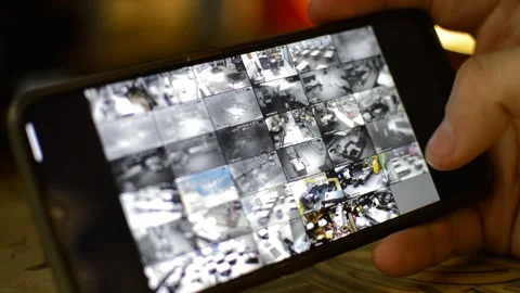 Surveillance security technology cctv on the phone monitor. split screen display Stock Footage 169643663