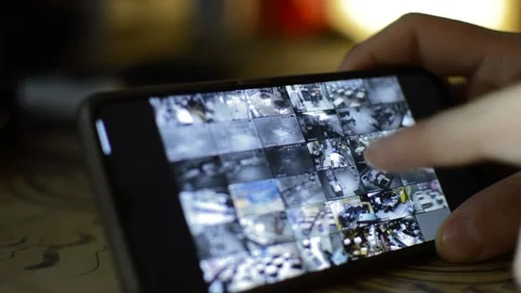 Surveillance security technology cctv on the phone monitor. split screen display Stock Footage 169643735