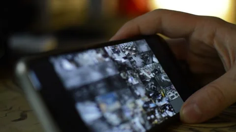 Surveillance security technology cctv on the phone monitor. split screen display Stock Footage 169643833