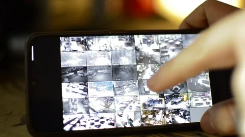 Surveillance security technology cctv on the phone monitor. split screen display Stock Footage 169643934