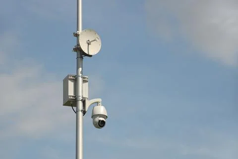 Surveillance system with an orange warning light located on a pole in the o.. Stock Photos