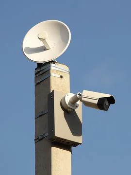 Surveillance system with an orange warning light located on a pole in the o.. Stock-Fotos